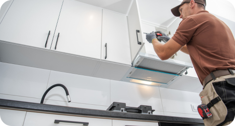man doing cabinet repairs